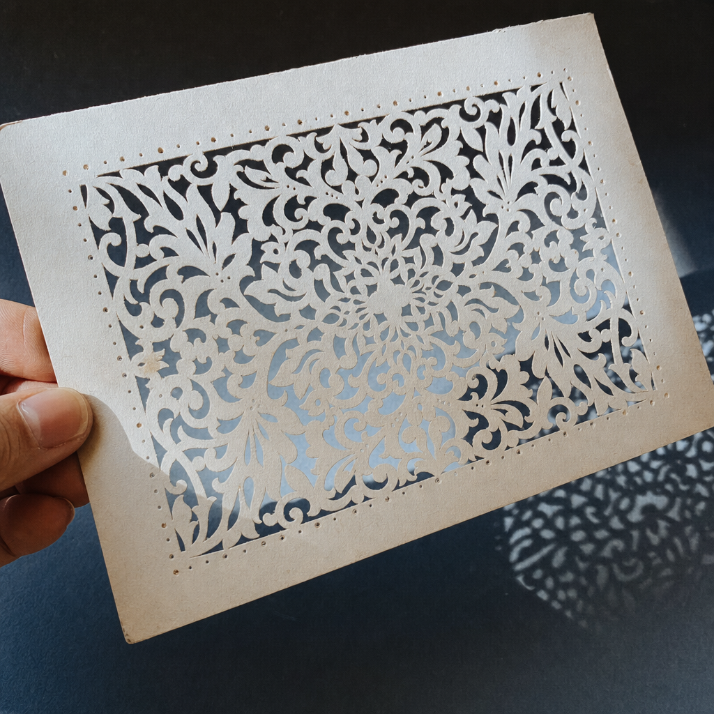 An intricate laser die-cut card with filigree detail