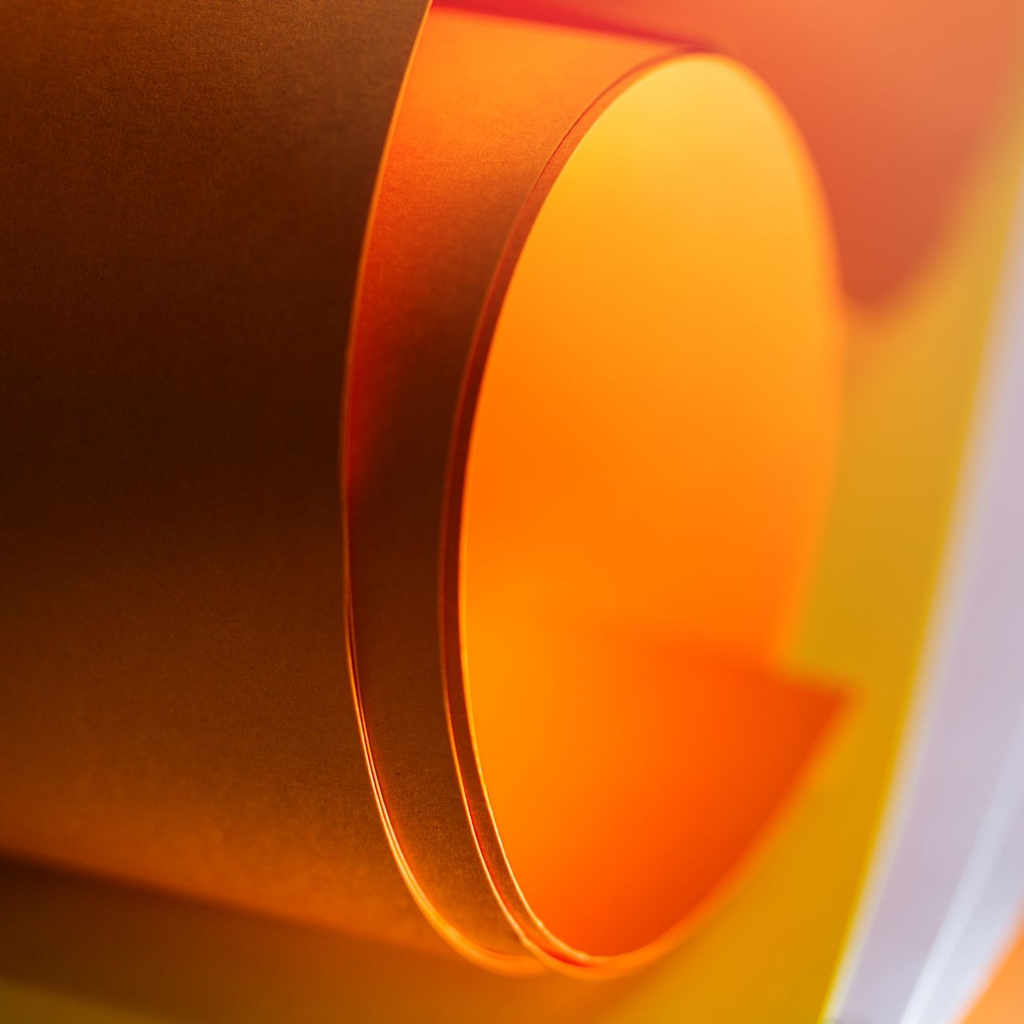 A stack of thick triplexed cards showing a coloured painted edge